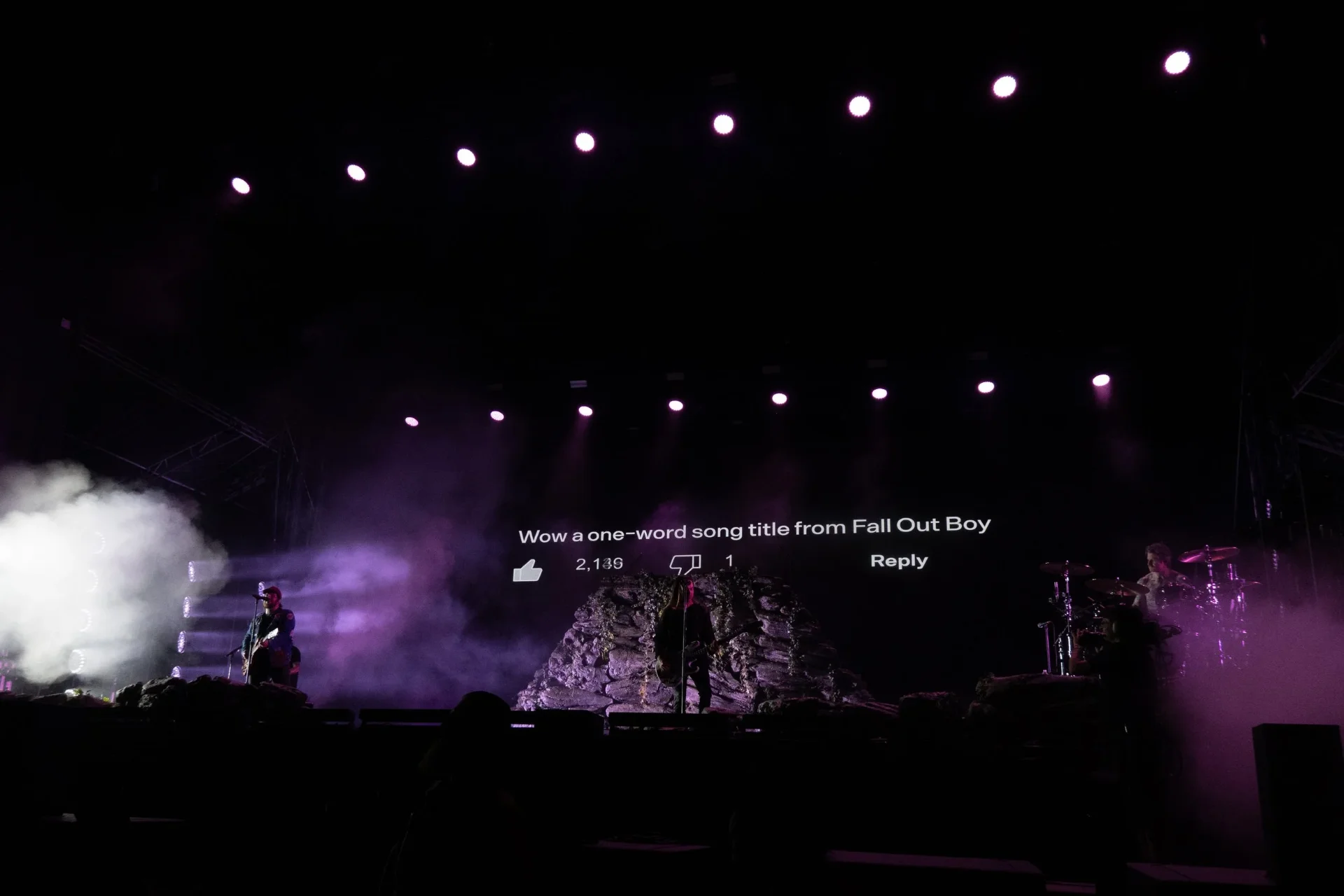 Wow a one-word song title from Fall Out Bow on a screen behind the band